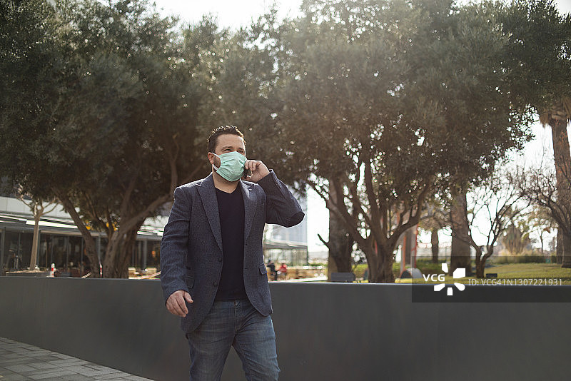 戴防护口罩在街上的男人图片素材