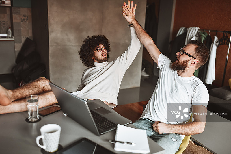 男学生在家成功完成学校项目后击掌图片素材