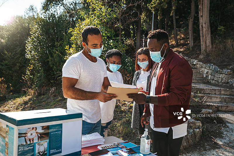 不同文化背景的年轻志愿者在街头分发宣传单图片素材