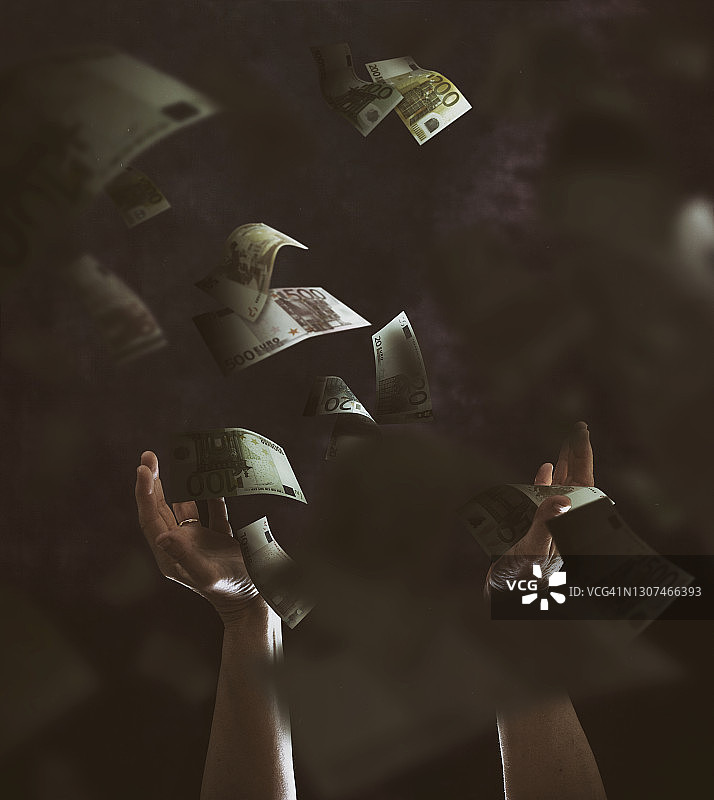 试图抓住从天而降的欧元纸币图片素材