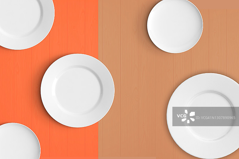 橙色背景下的空陶瓷盘俯视图图片素材