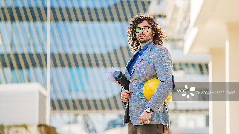 在建筑物前戴防护头盔的建筑师图片素材