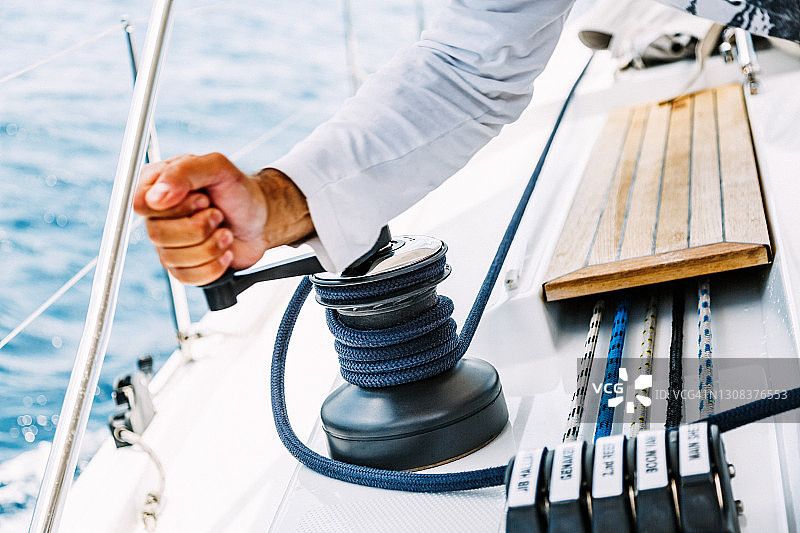 水兵用手在绞盘上缠绕绳索图片素材