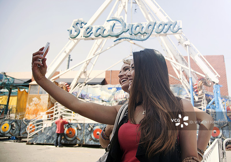 在游乐园自拍的女性朋友图片素材
