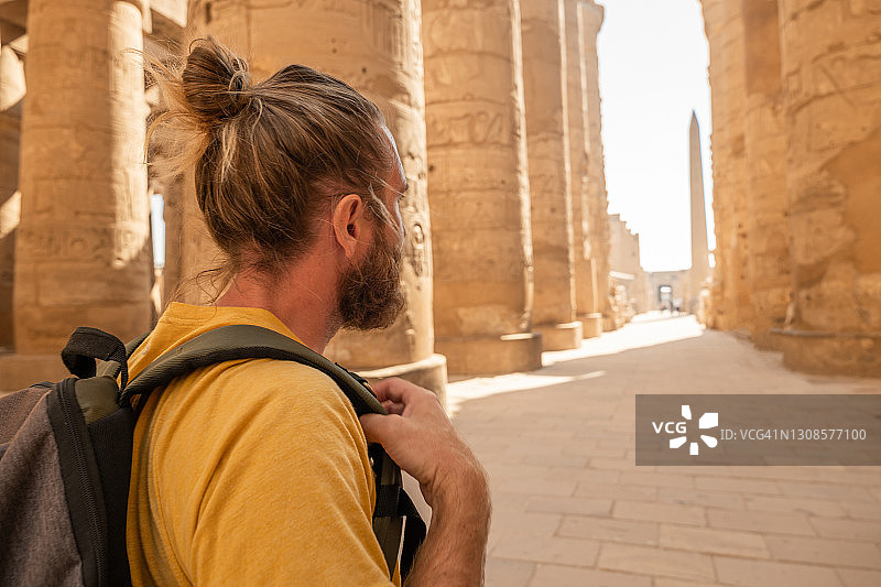 在卢克索探索古老寺庙的背包客的侧视图图片素材