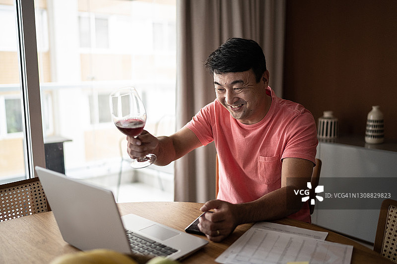 在家参加虚拟欢乐时光举杯的快乐男人图片素材