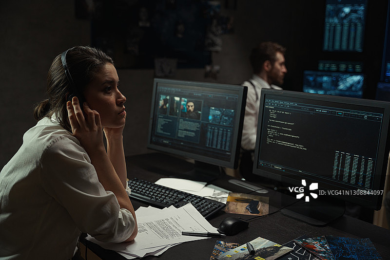 女人皱着眉头，试图听到耳机里微弱的声音图片素材