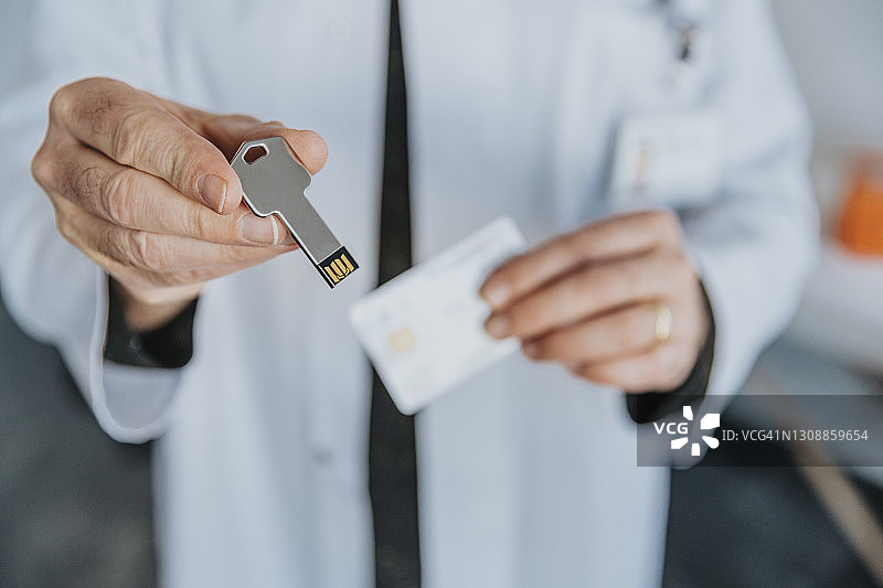 男医生在诊所手持USB存储器图片素材