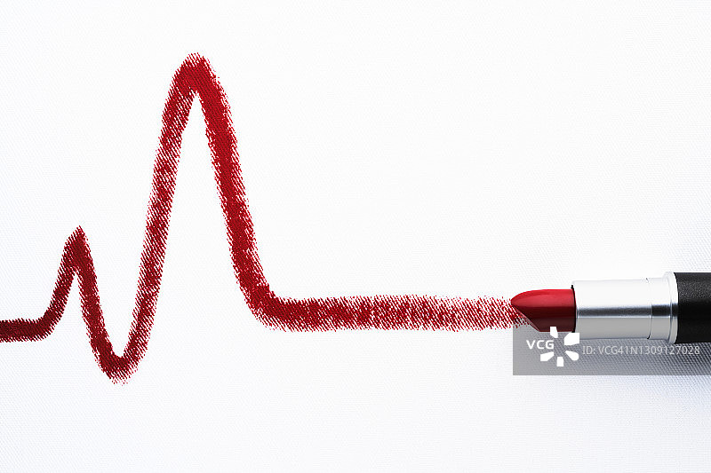 红色唇膏在白纸上画出心跳线图片素材