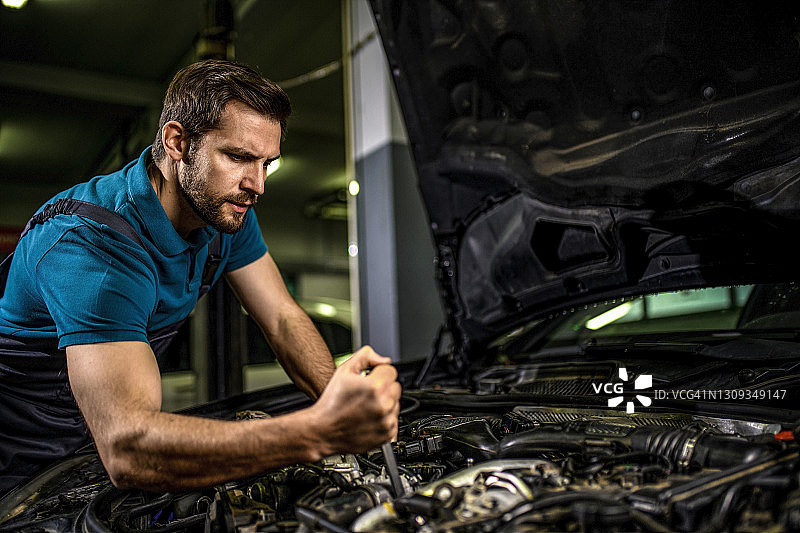 技工在修理厂修理汽车发动机图片素材