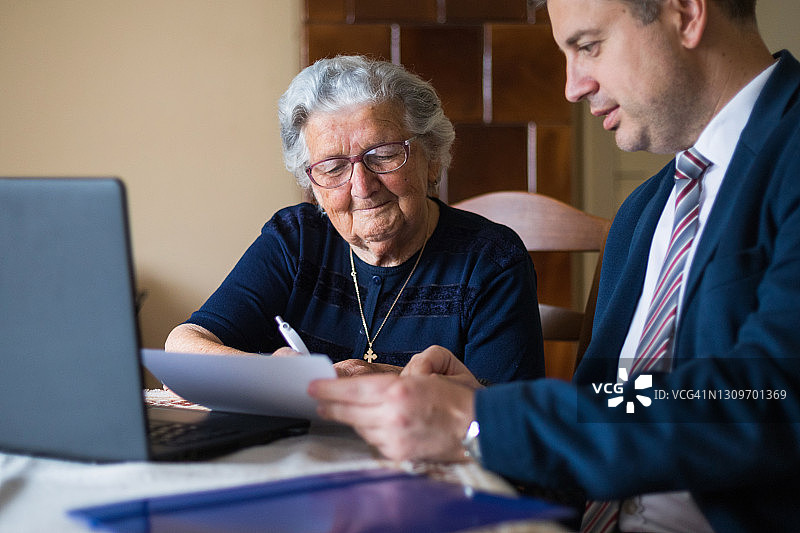 律师向年长的客户展示法律文件图片素材