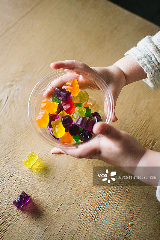 小女孩玩彩色小熊软糖图片素材