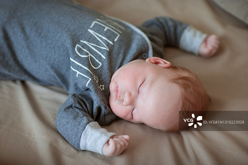 在床上甜蜜睡觉的漂亮宝宝图片素材