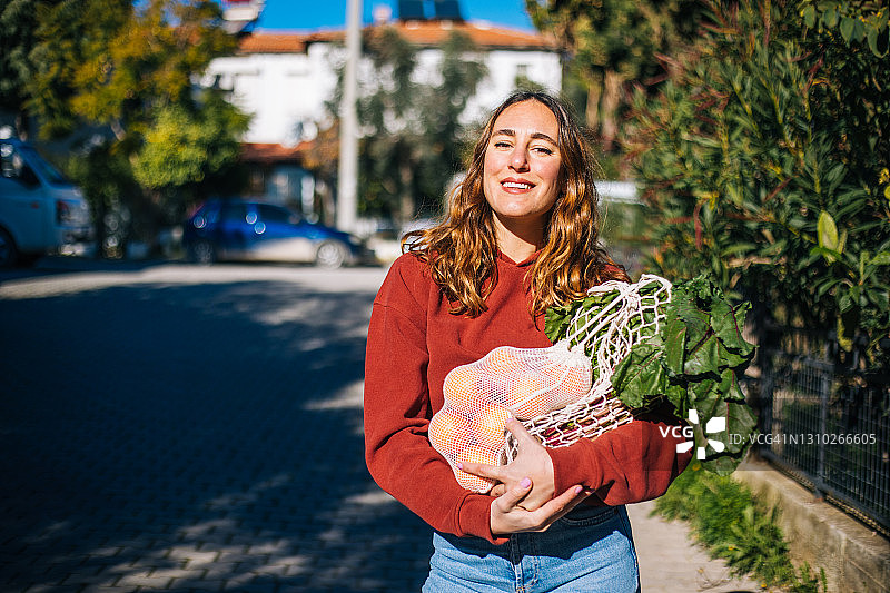 女人用可重复使用的棉质环保袋购买水果和蔬菜图片素材