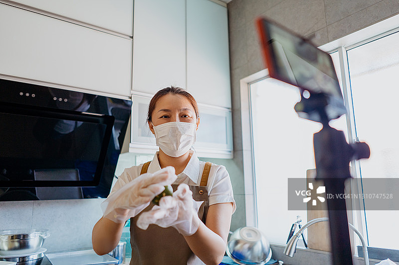 中国女性用智能手机直播烘焙教程图片素材