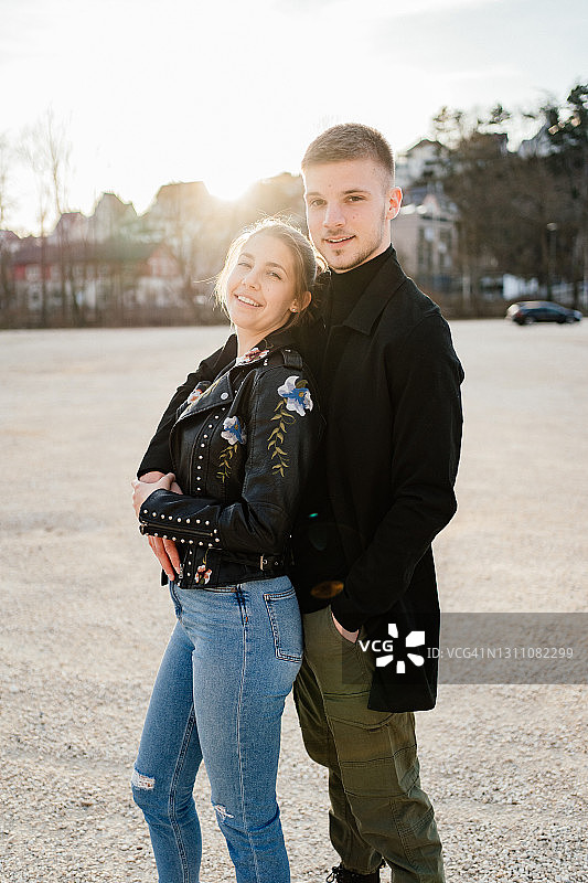 年轻夫妇在空旷的停车场里拥抱图片素材