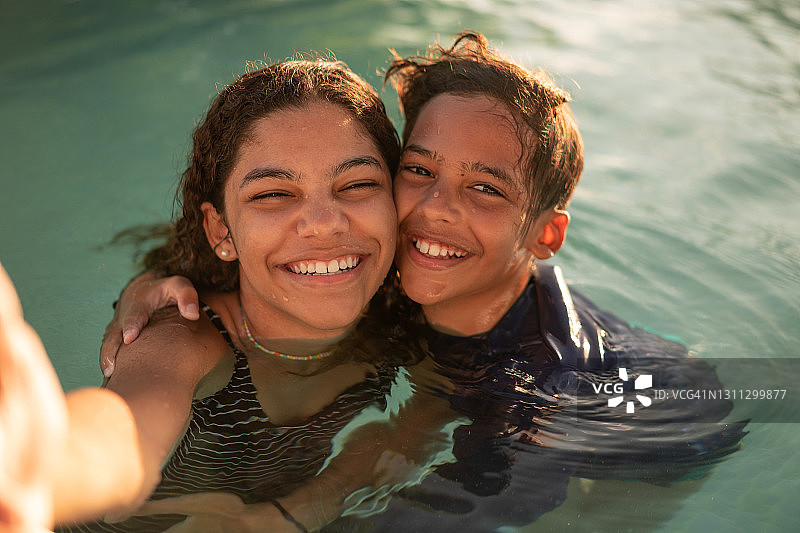 兄弟姐妹在泳池边自拍图片素材