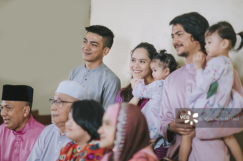 马来西亚马来家庭在家中拍照庆祝开斋节图片素材