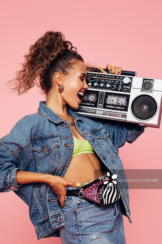 拿着卡式录音机的时髦女孩的画像图片素材