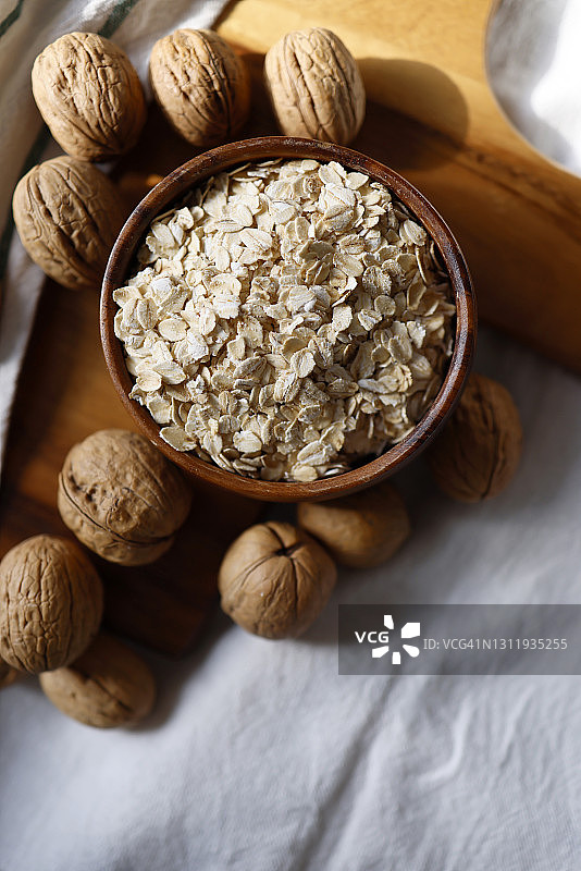 木质餐盘燕麦片、桌布和核桃图片素材