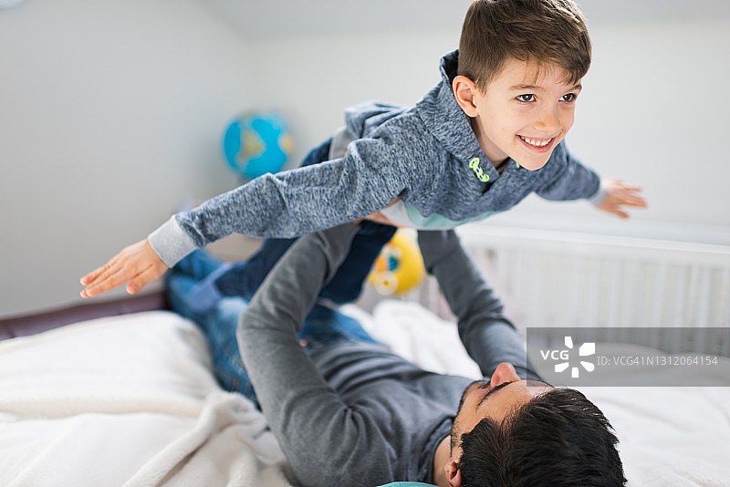 父子在床上玩耍图片素材
