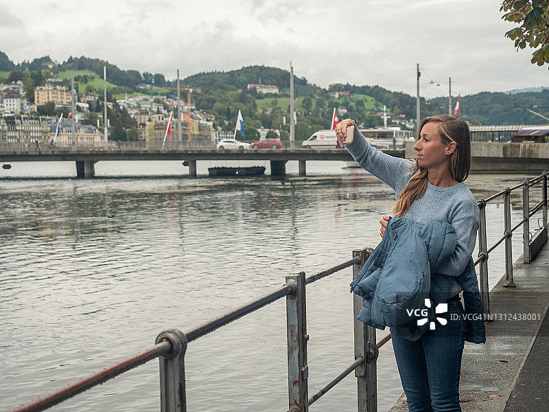 年轻女人拍摄琉森城市和著名桥梁图片素材