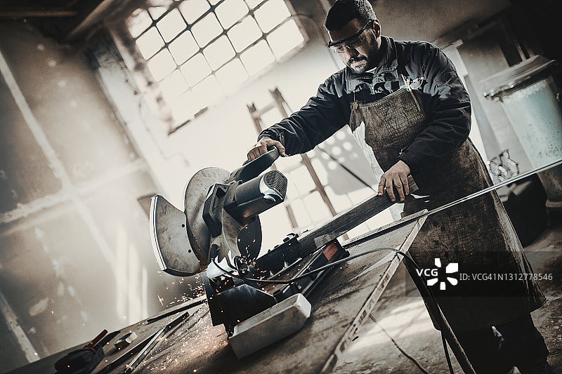 焊接工人在圆锯上切割金属图片素材
