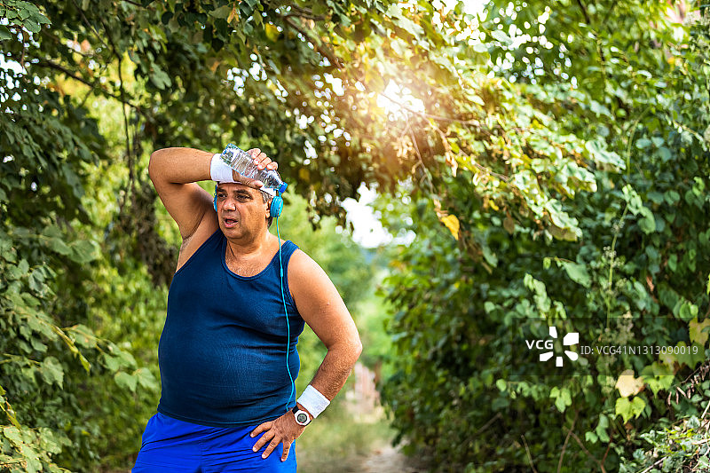 在公园跑步后疲惫的超重男人图片素材