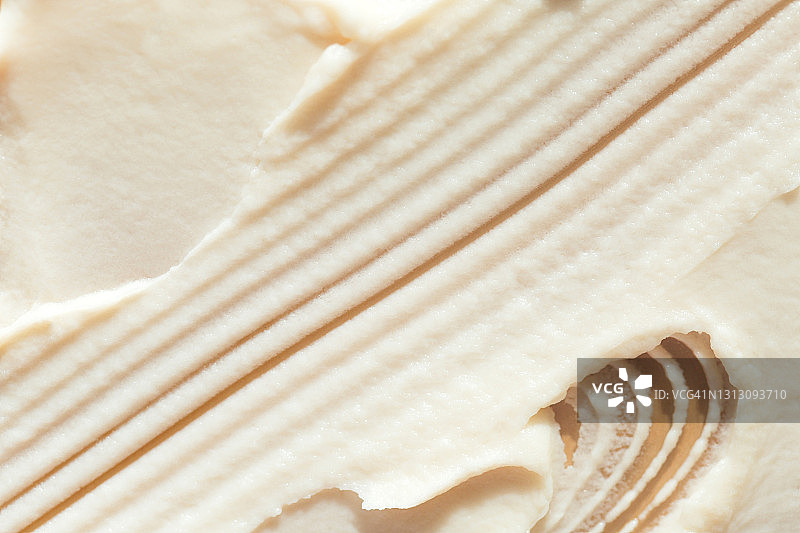 米色背景上的香草冰淇淋或柠檬冰糕的纹理笔触，扁平风格图片素材