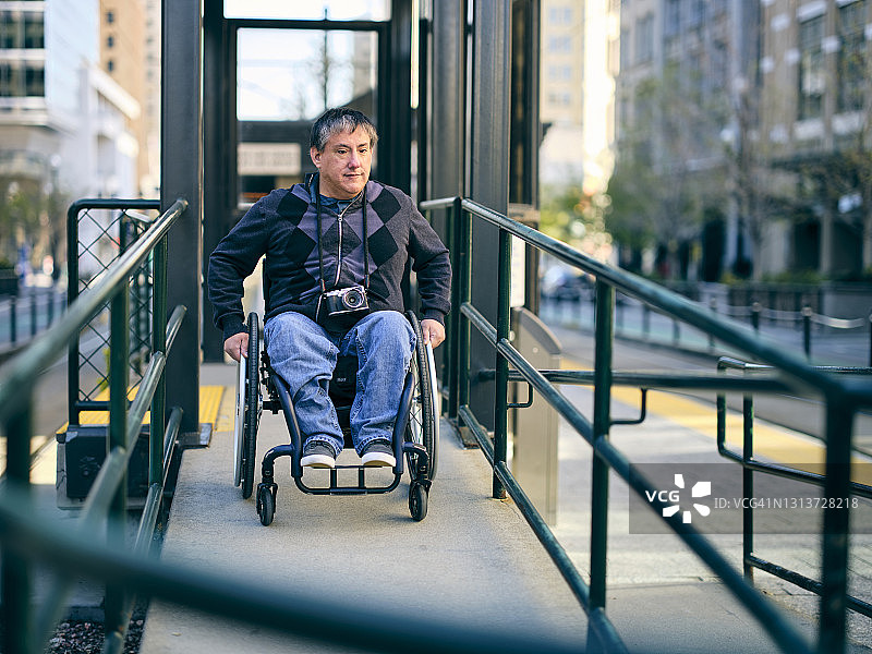 轮椅上的残疾男子在轮椅坡道上图片素材