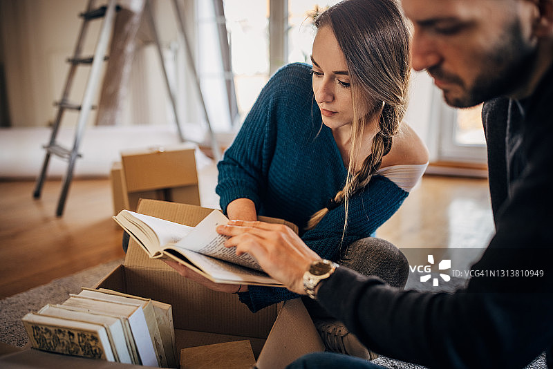 年轻情侣在新公寓里打开行李图片素材