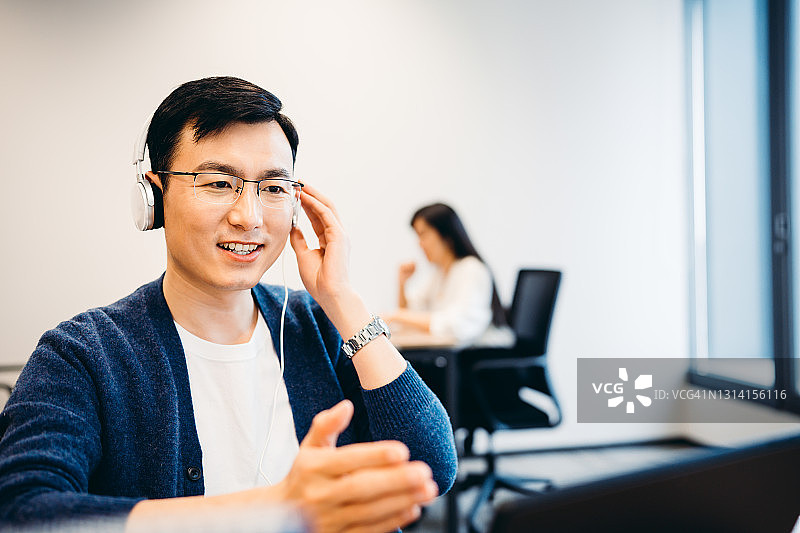 年长的亚洲男人在办公室用笔记本电脑进行视频通话图片素材