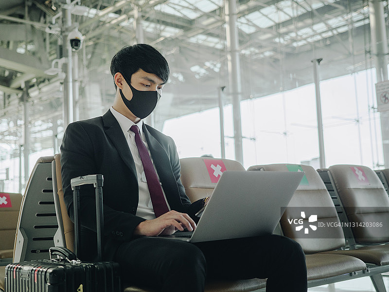 戴口罩的亚洲男人在机场图片素材