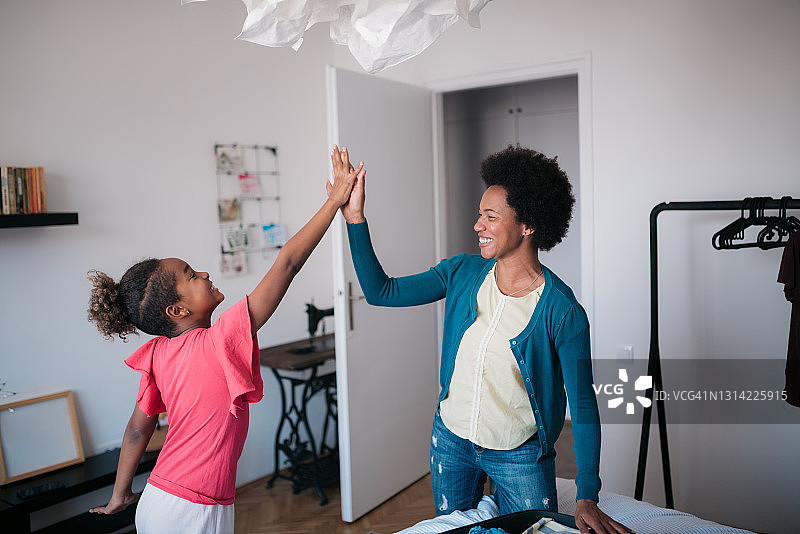 收拾行李的中年非裔美国妇女和她的女儿图片素材