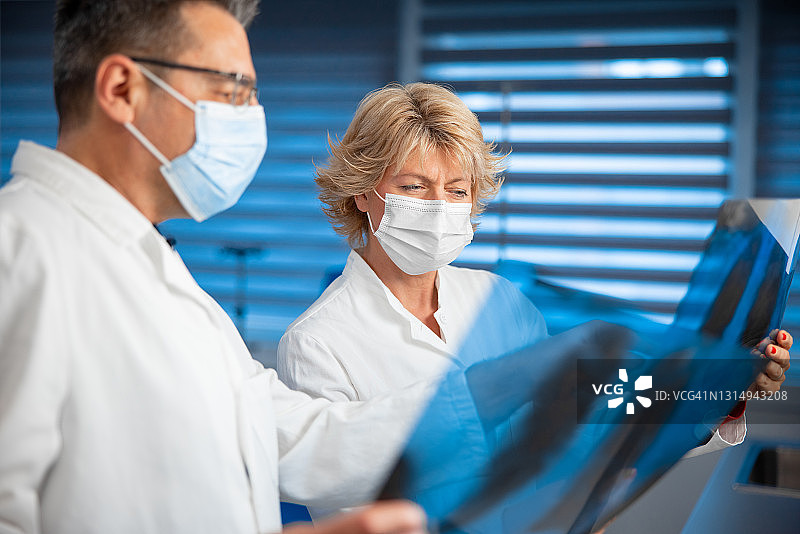 肺科医生佩戴口罩对比肺部X光片图片素材