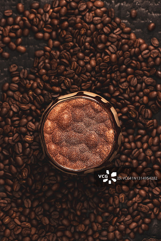 玻璃杯中的冰咖啡，用巧克力装饰的时尚搅打咖啡，黑色背景图片素材