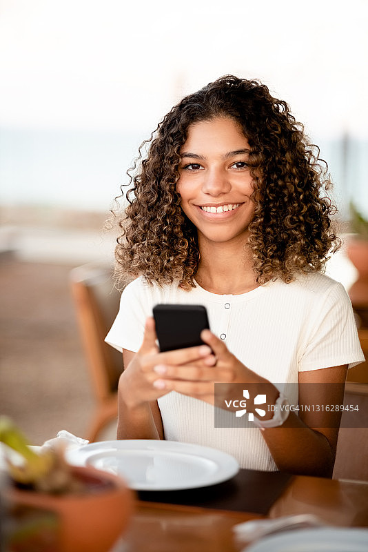女人坐在咖啡馆里使用智能手机图片素材