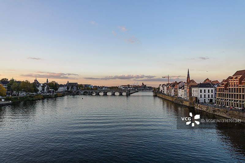 日落时分荷兰马斯特里赫特默兹河畔辛特·瑟瓦斯布吕赫历史人行桥和城市景观图片素材