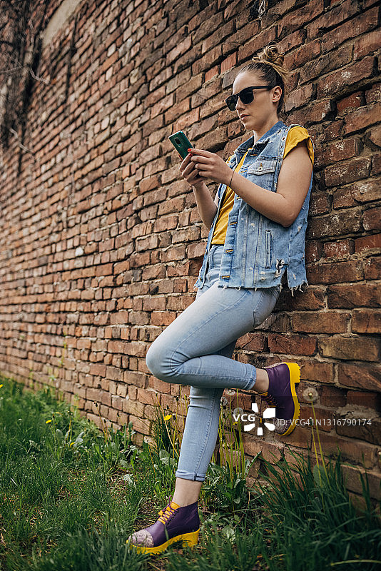 砖墙旁的现代女性图片素材