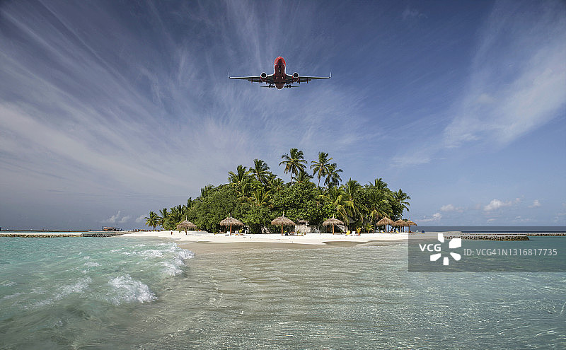 飞越热带岛屿的飞机图片素材