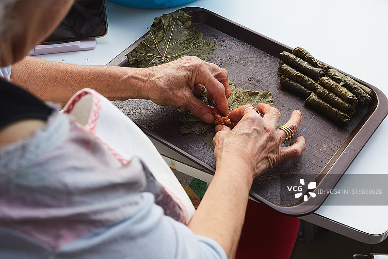 准备葡萄叶卷饼的女子图片素材