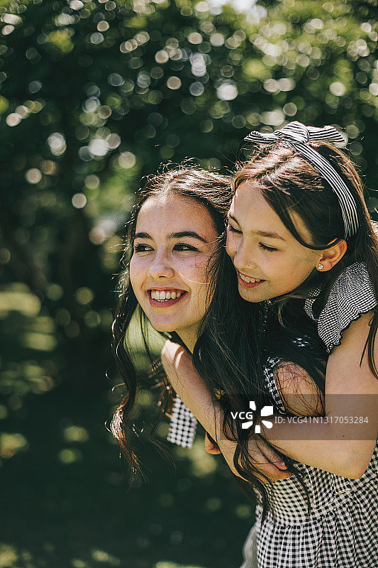 后院里兄妹互相背着图片素材