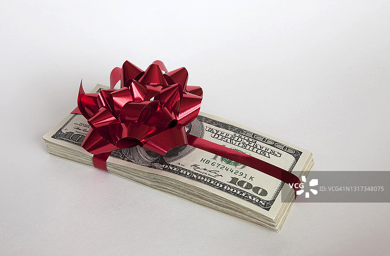 带红色蝴蝶结的钱堆图片素材