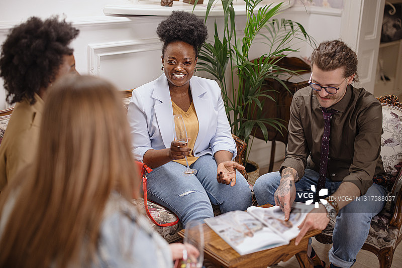 设计师向准新娘和朋友展示婚纱作品图片素材