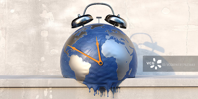 混凝土架子上融化的地球仪闹钟，橙色指针指向午夜图片素材
