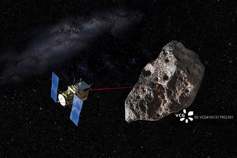 小行星研究航天器用激光击中小行星以获取样本的概念图片素材