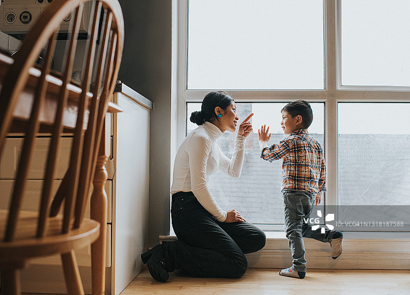 母子一起看大公寓的窗外图片素材