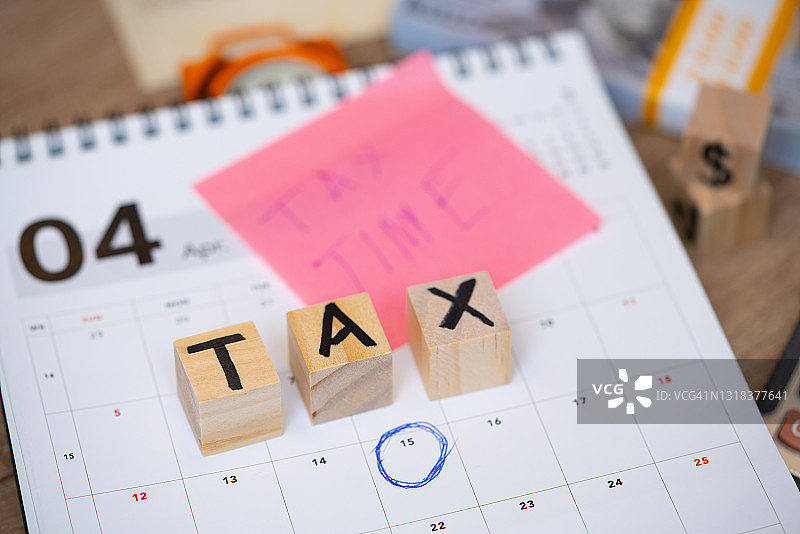 办公室工位上的时钟与“税务”字样，商业概念图片素材