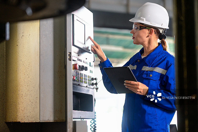 女工程师在金属零件工厂检查数控机床启动前的情况图片素材