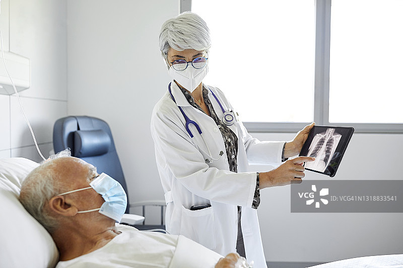 医生在重症监护室向病人展示X光片图片素材